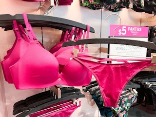 a pink bra and panty by a sale sign