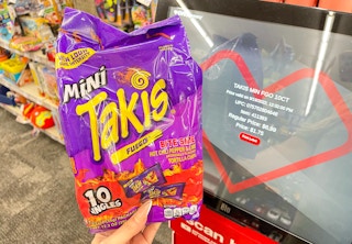 hand holding mini takis next to coupon center