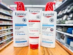 three bottles of eucerin on counter at walmart