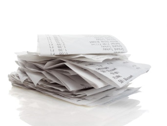 Stack of receipts piled high on white background