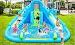 Lifestyle image of a inflatable water park set up outdoors