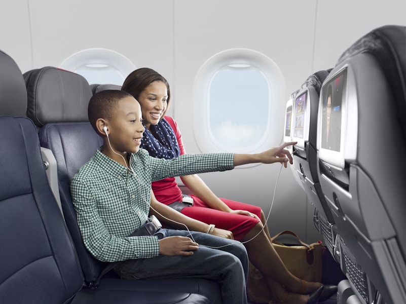 A mom and her son sitting in their seats on an American Airlines flight