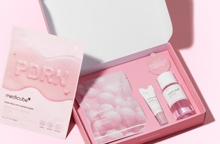 a pink box with mini skincare products inside