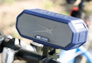 blue and gray wireless speaker mounted on a bike