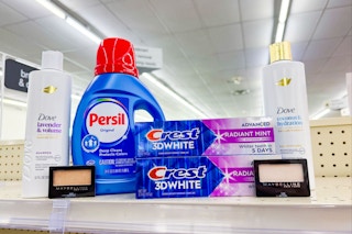 dove shampoo, persil detergent, crest toothpaste, and maybelline eyeshadow on a shelf