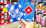 hand holding bath and body works and dominos gift cards