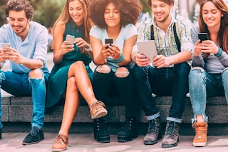 a group of people playing with their phones