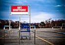 shopping cart sits in an empty lot