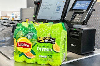 a package of lipton ice tea with uber eats code sittig at a walmart self checkout