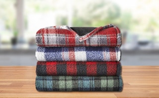 a stack of plaid travel blankets