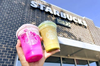 someone holding up two starbucks wicked drinks outside of starbucks