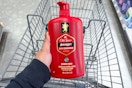 hand holding old spice body wash above a shopping cart