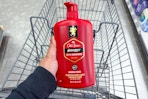 hand holding old spice body wash above a shopping cart