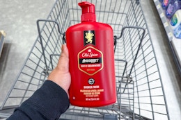hand holding old spice body wash above a shopping cart