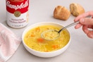 bowl of soup next to the can