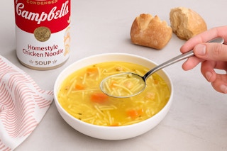 bowl of soup next to the can