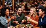 A group of people enjoy drinks and food at Applebees