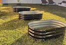 three raised garden beds in a yard
