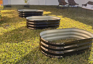 three raised garden beds in a yard