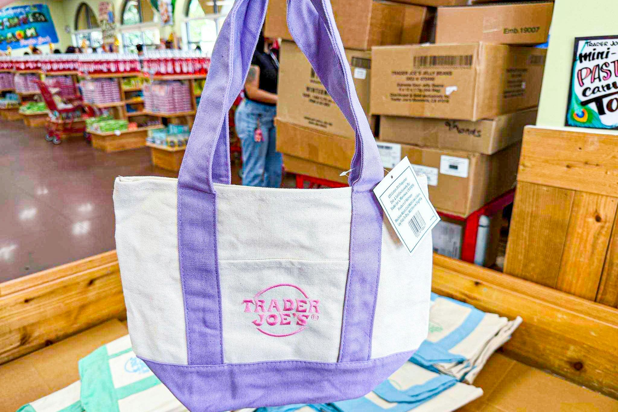 hand holding trader joes mini pastel tote