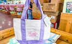 hand holding trader joes mini pastel tote