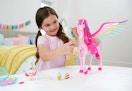 child playing with a Barbie Pegasus play set