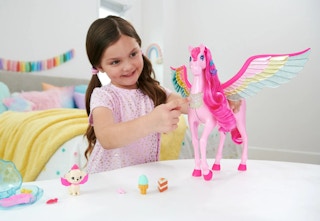 child playing with a Barbie Pegasus play set