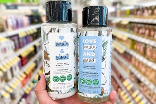 hand holding a couple bottles love beauty and planet hair care in store aisle