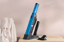 a teal handheld Shark vacuum