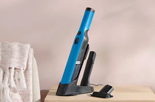 a teal handheld Shark vacuum