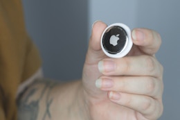 someone holding up an airtag