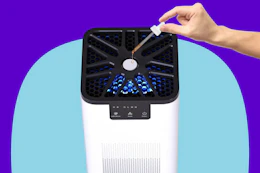 Stock photo of person adding essential oils to air purifier (close up shot)