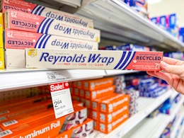 hand grabbing reynolds wrap off a target shelf