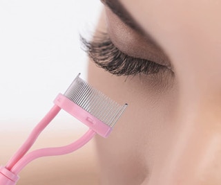 pink eyelash comb near an eye