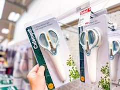 hand holding a cuisinart kitchen shears set in front of target shelf