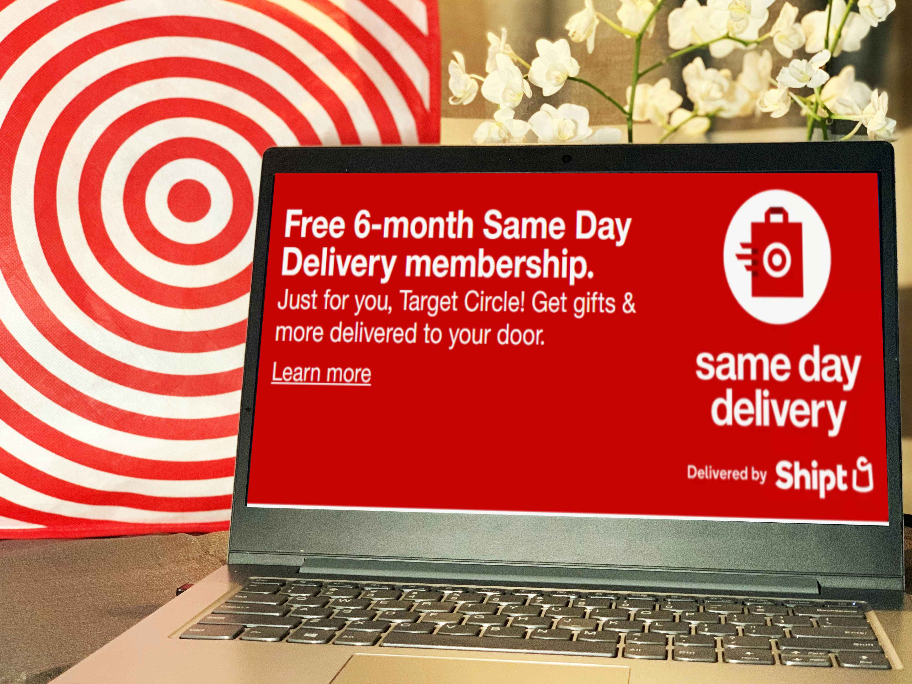 laptop in front of target bag and orchids with same day delivery by shipt