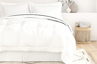Linens & Hutch Bed in a Box White Bedding Set on a bed with a wicker basket next to it