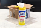 a container of lysol disinfecting wipes in front of an amazon box