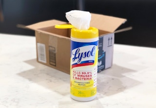 a container of lysol disinfecting wipes in front of an amazon box