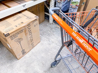 Home Depot shopping cart next to Hampton Bay Heat-Focusing Outdoor Gas Heater