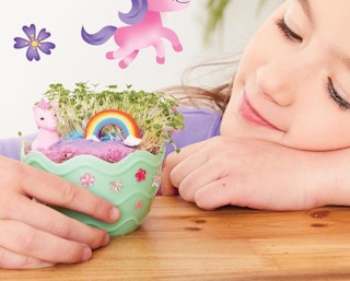 a little girl holding a mini mermaid garden 