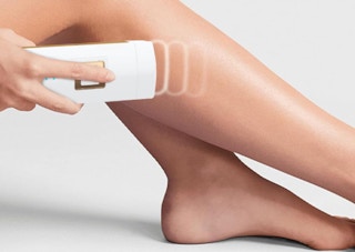 a laser hair removal device being used on someone's legs