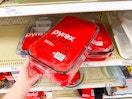 hand grabbing a pyrex bakeware set off a target shelf