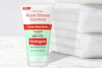 Neutrogena Acne Scrub next to stack of towels