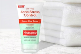 Neutrogena Acne Scrub next to stack of towels
