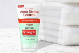 Neutrogena Acne Scrub next to stack of towels