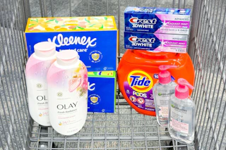 kleenex tissues, olay body wash, crest toothpaste, tide pods, and garnier micellar cleanser in a cart