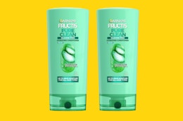 two green bottles of conditioner