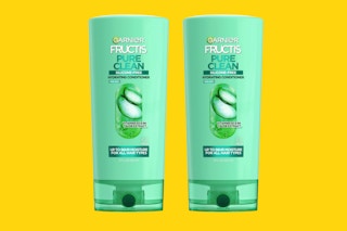 two green bottles of conditioner