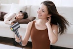 a woman using an ionic hair dryer